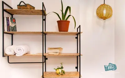 a shelf system with wooden shelves and a plant at Supertramp Hostel Machupicchu in Machu Picchu