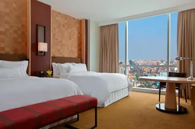 a hotel room with two beds and a large window at The Westin Lima Hotel & Convention Center in Lima