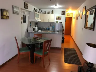a kitchen and dining room with a table and chairs at A Perfect Vacation Getaway Apartment in Lima