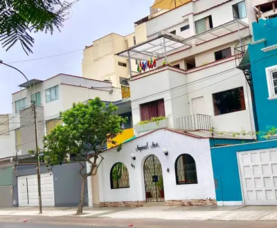 a building with a tree in front of it at Imperial Inn Hospedaje Turistico in Lima
