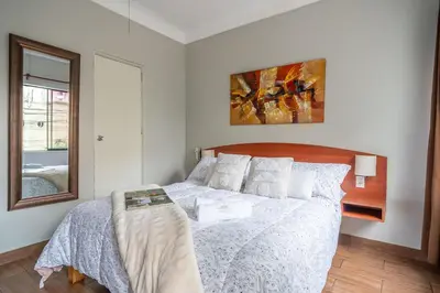 a bedroom with a bed with a white comforter at Imperial Inn Hospedaje Turistico in Lima