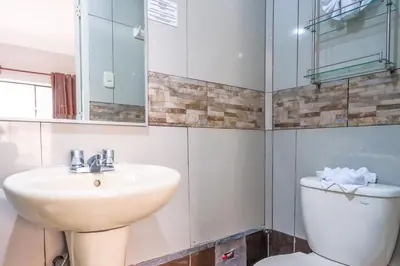 a bathroom with a sink and a toilet at Imperial Inn Hospedaje Turistico in Lima