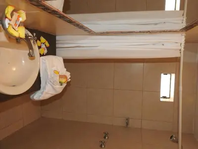 a bathroom with a sink and a towel rack at Hostal Samichay in Cusco
