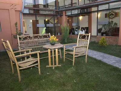 a table and two chairs and a table and a table and chairs at Hostal Samichay in Cusco