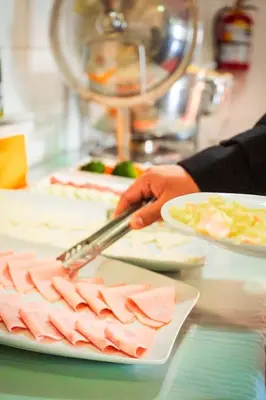 a person cutting meat on a plate with a knife at Siete Ventanas in Cusco