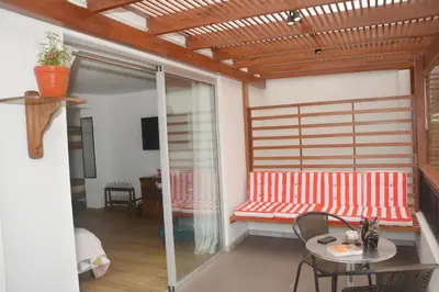 a living room with a red bench and a table at Barranco Wasi in Lima