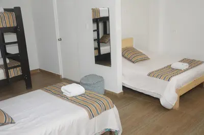 a room with two beds and a mirror at Barranco Wasi in Lima