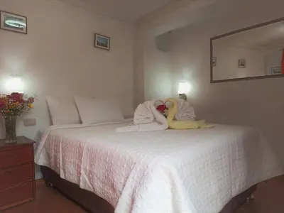 a bedroom with a bed with two stuffed animals on it at Hostal Tu Hogar in Cusco
