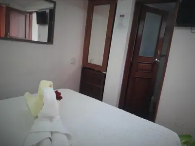 a stuffed animal is sitting on a bed at Hostal Tu Hogar in Cusco