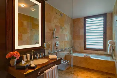 a bathroom with a sink and a tub and a mirror at Tambo del Inka, a Luxury Collection Resort & Spa, Valle Sagrado in Urubamba