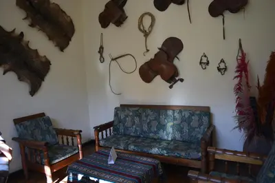 a living room with a couch and two chairs at El Tuco Hotel in Cusco