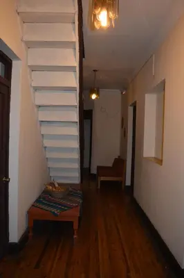 a staircase in a room with a wooden floor at El Tuco Hotel in Cusco