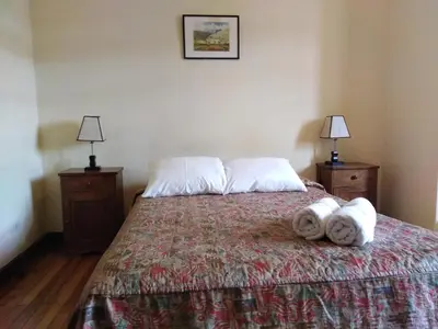 a bedroom with a bed with towels on it at El Tuco Hotel in Cusco