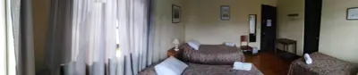a room with two chairs and a couch and a window at El Tuco Hotel in Cusco