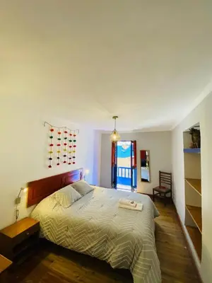 a bedroom with a large bed and a window at Flying Dog Hostel Cusco in Cusco