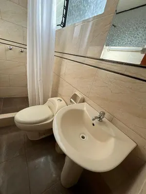 a bathroom with a sink and a toilet at Hostal Apu Qhawarina in Ollantaytambo