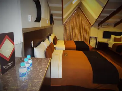 a hotel room with two beds with water bottles on a counter at Hotel San Francisco Plaza in Cusco