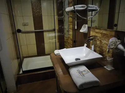 a bathroom with a sink and a shower and a tub at Hotel San Francisco Plaza in Cusco