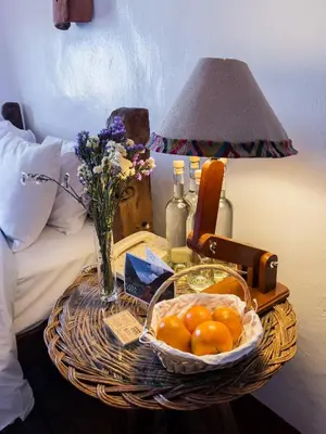 a table with a basket of oranges on a bed at El Balcón in Cusco