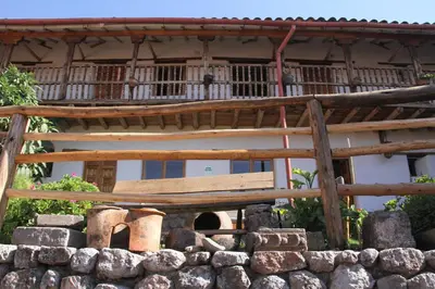 a building with a balcony and a stone wall at El Balcón in Cusco