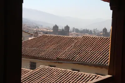 a view of roofs of a city from a building at El Balcón in Cusco