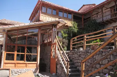 a house with wooden stairs leading up to it at El Balcón in Cusco