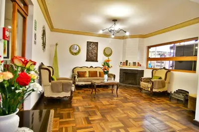 a living room with couches and a fireplace at Centenario Inn in Cusco