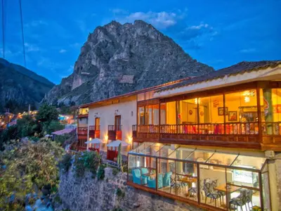 a hotel with a mountain in the background at Sol Ollantay Boutique Hotel in Ollantaytambo