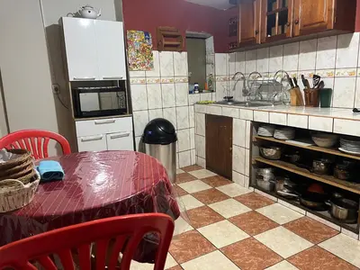a kitchen with a table and a counter top at Casa Salkantay Cusco in Cusco