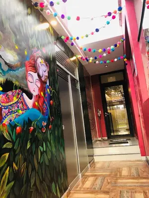 a painting of a woman on the wall of a building at Hostal Patiño in Lima
