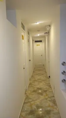 a hallway with a long corridor with a door at Hostal Patiño in Lima