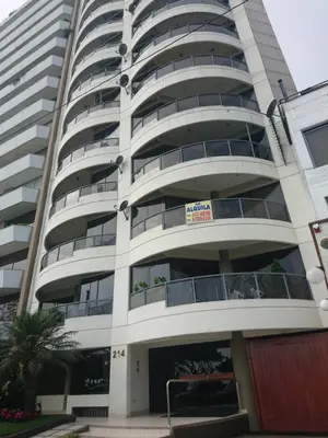 an apartment building with a parking garage at Malecón in Lima