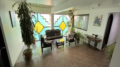 a living room with a couch and chairs and a table at Hotel Quilla in Urubamba