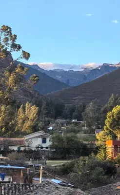 a view of a town with mountains in the background at Hotel Quilla in Urubamba