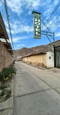 an empty street with a sign on the side of a building at Hotel Quilla in Urubamba