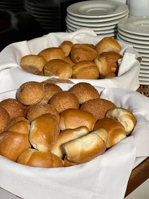 two plates of buns are sitting on a table at Hatun Inti Classic in Machu Picchu