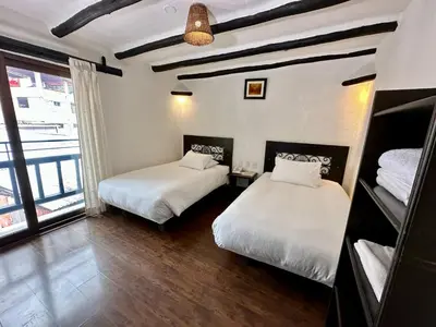 a room with two beds and a window at Hatun Inti Classic in Machu Picchu