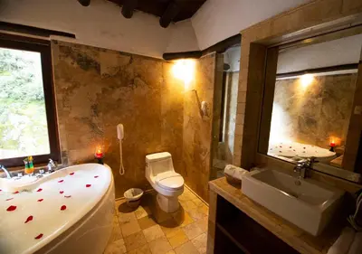 a bathroom with a tub and a toilet and a sink at Hatun Inti Boutique in Machu Picchu
