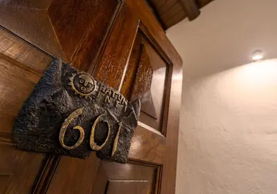 a wooden door with the word god written on it at Hatun Inti Boutique in Machu Picchu