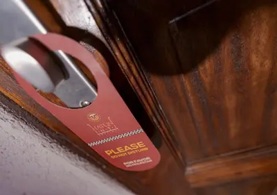 a red tag on a wooden door at Hatun Inti Boutique in Machu Picchu