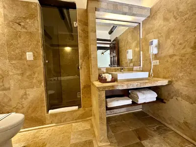 a bathroom with a toilet and a sink and a mirror at Hatun Inti Boutique in Machu Picchu
