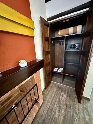 a walk in closet in a room with wooden floors at Hatun Inti Boutique in Machu Picchu