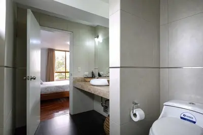 a bathroom with a toilet and a sink and a mirror at Departamento en San Isidro, Lima in Lima