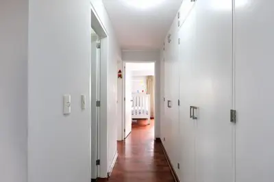 a hallway with white doors and a wooden floor at Departamento en San Isidro, Lima in Lima