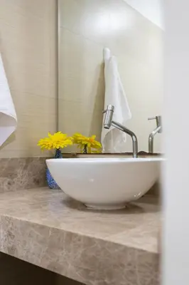 a white sink in a bathroom with a mirror at Departamento en San Isidro, Lima in Lima