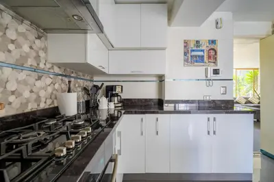 a kitchen with white cabinets and a stove at Departamento en San Isidro, Lima in Lima