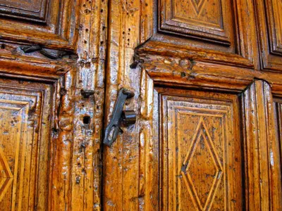 an old wooden door with a metal handle at Unaytambo Boutique Hotel Cusco in Cusco