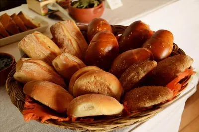 a pile of buns in a basket on a table at Unaytambo Boutique Hotel Cusco in Cusco