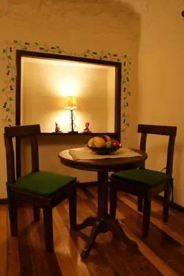 a table and two chairs in front of a mirror at Unaytambo Boutique Hotel Cusco in Cusco