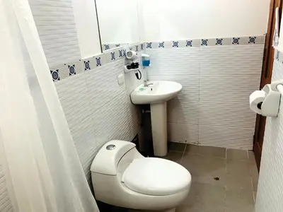 a small bathroom with a toilet and a sink at Inka Khawarina Tambo Lodge in Ollantaytambo